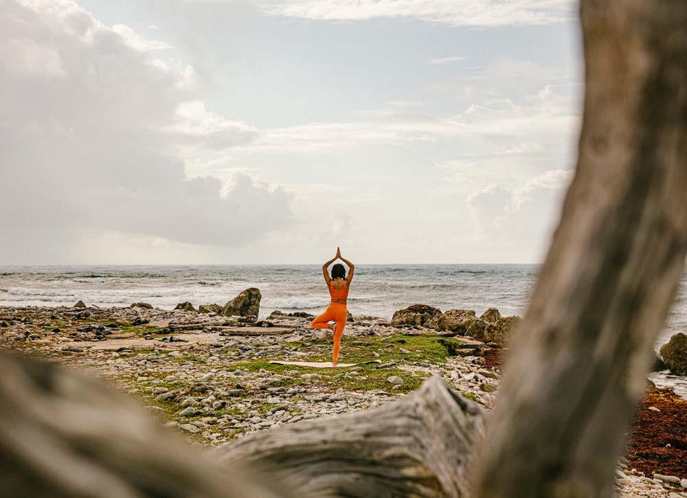 Woman doing yoga on beach