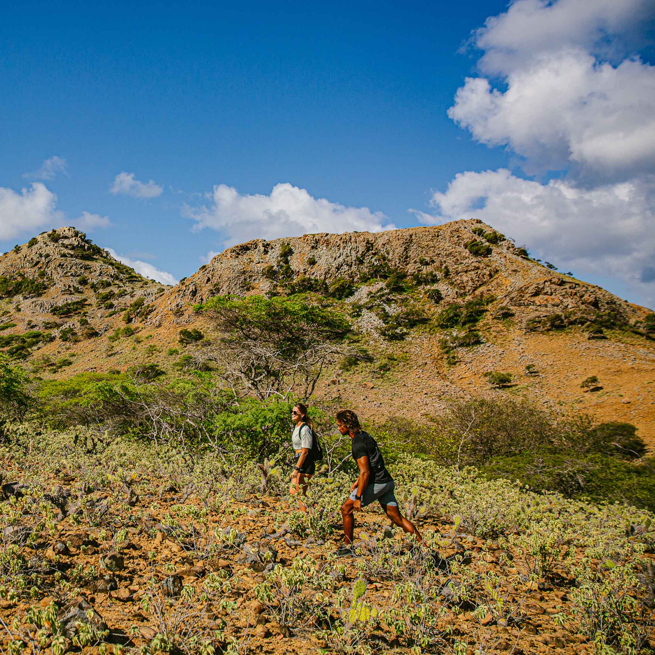 Male and female hiking on mountain