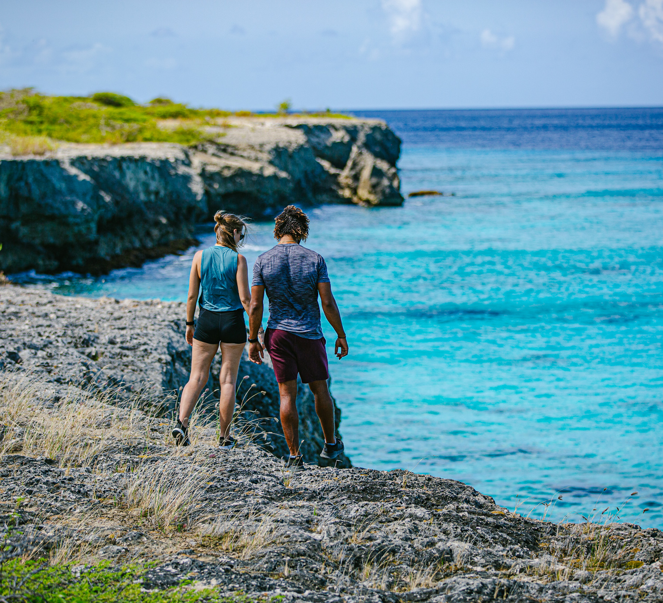 Man and woman walking near a cliff's edge
