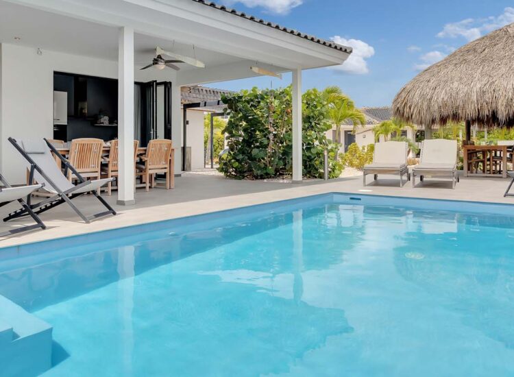 Outdoor pool area surrounded by lounge chairs