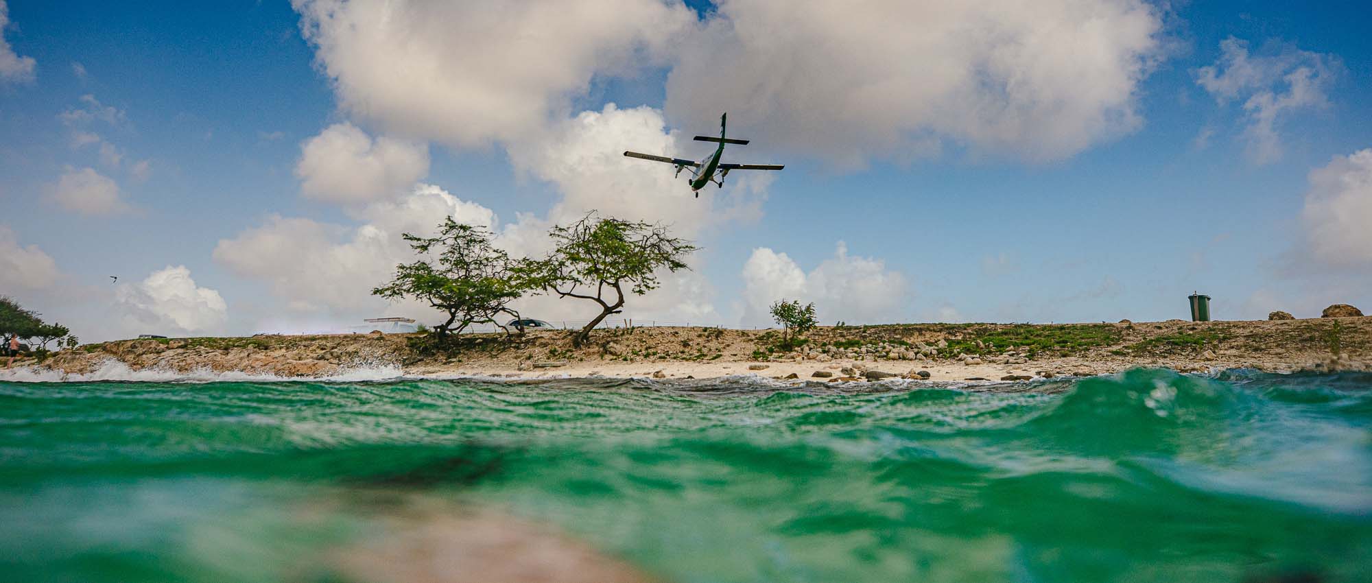 Airplane in sky over beach