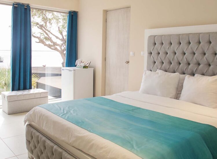 Hotel room with large bed, desk, and an ocean view