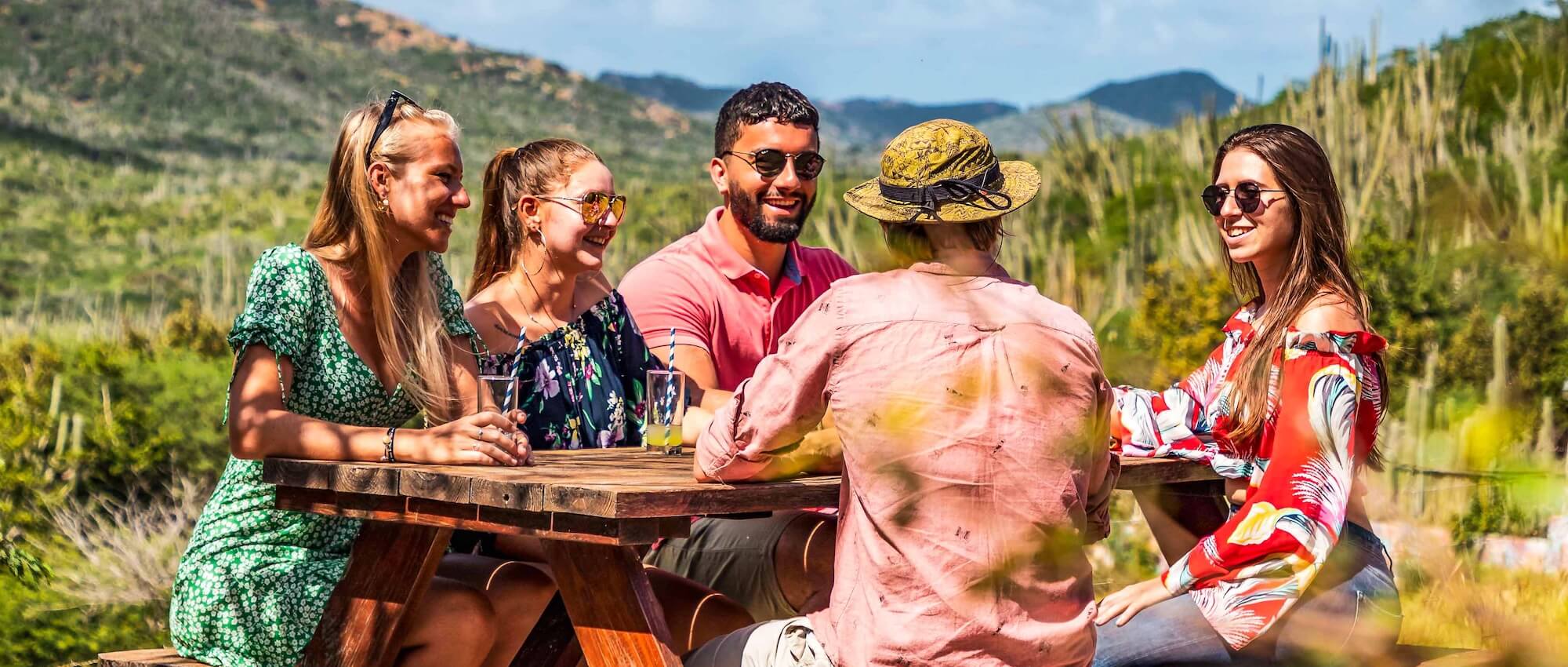 Group of friends sitting outside at picnic table