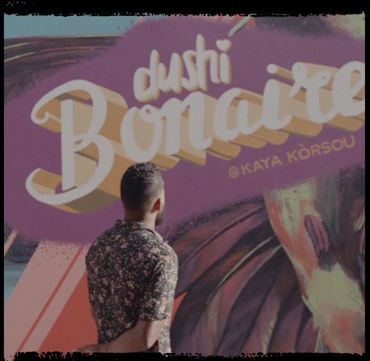 Man looking at a mural on the wall