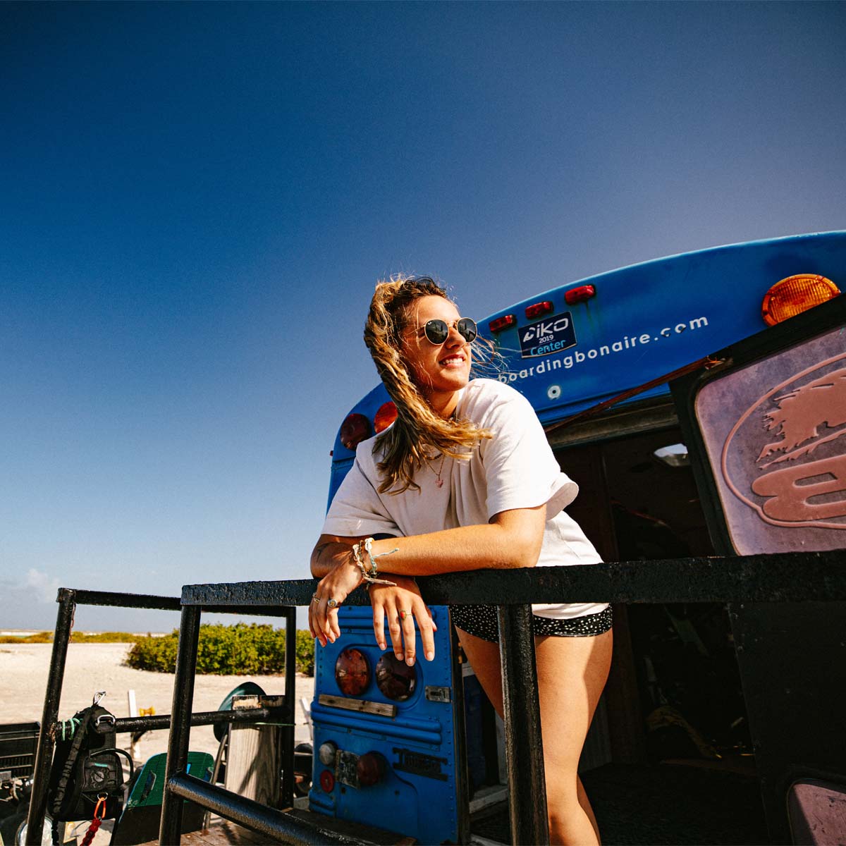 Woman standing on back of truck trailer
