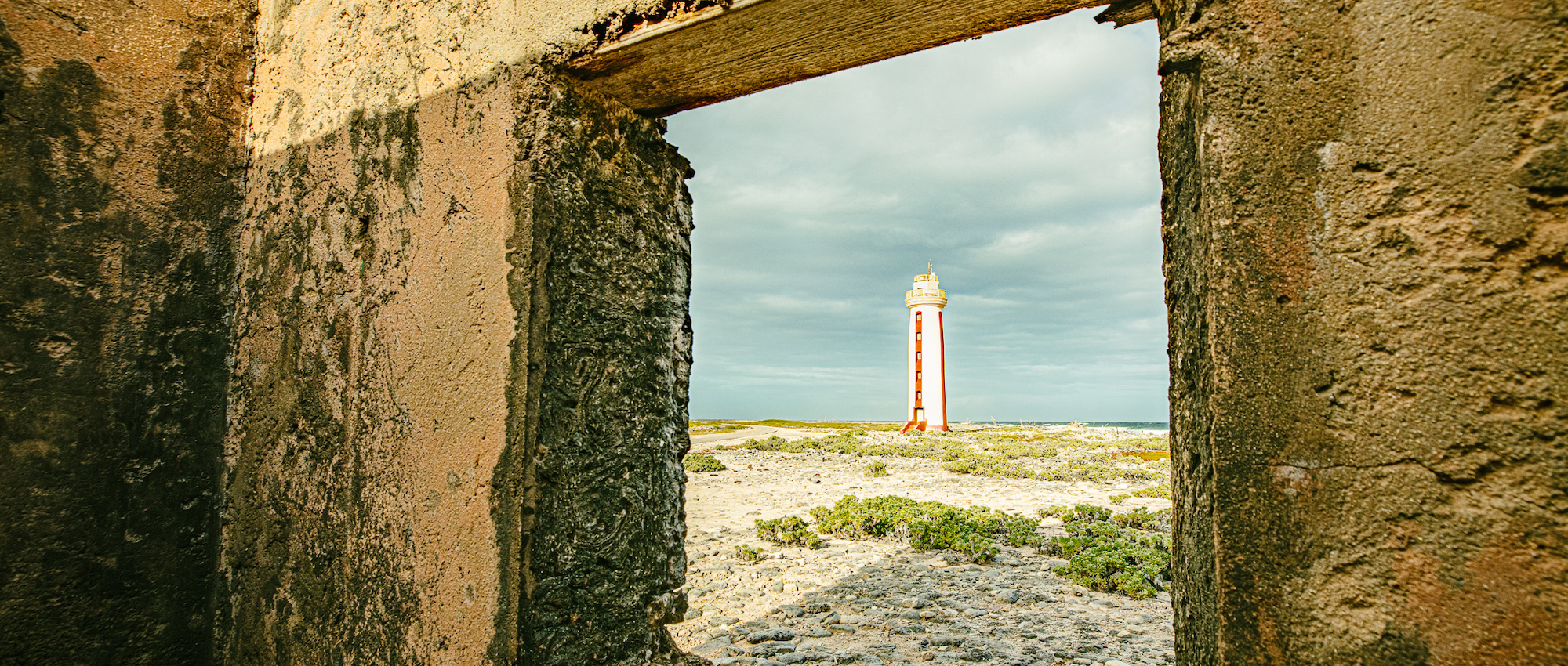 lighthouse seen through historical building's window