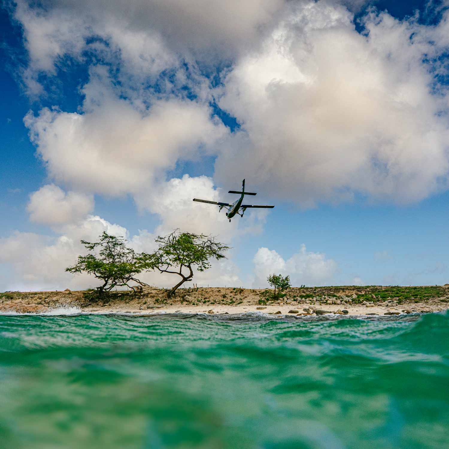 Airplane in sky over beach